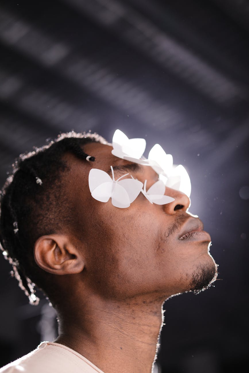 close up shot of a man with white butterflies on his face, blind, vision, trusting God's vision for our life