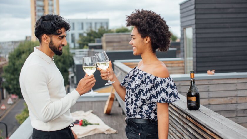 a couple toasting their glasses with white wine, vetting process, vetting question, vetting questions dating, dating, dating 2023, Spring 2023, Christian dating, Dating as a Christian