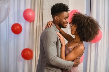 african american couple hugging and dancing near balloons in apartment, dating apps, best dating apps in 2023, dating apps for Christians, dating apps as a Christian, Christian dating apps, best dating apps