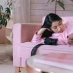 girl in pink long sleeve shirt using a phone, waiting season, waiting seasons