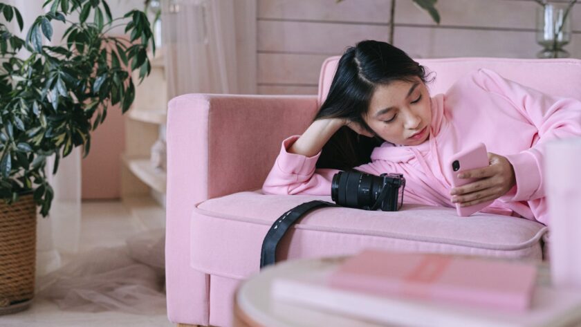 girl in pink long sleeve shirt using a phone, waiting season, waiting seasons