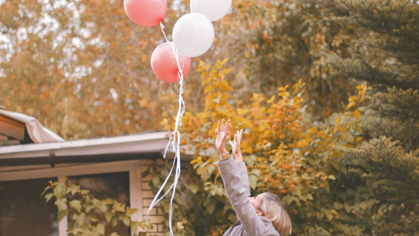 woman in gray jacket released balloons in the air, grieving the old you, grieve the old you, grieve the life you thought you'd have