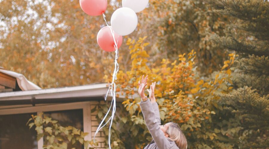 woman in gray jacket released balloons in the air, grieving the old you, grieve the old you, grieve the life you thought you'd have